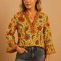 Women’s boho floral print blouse in orange with flared sleeves and high neckline, ideal for spring outings, summer parties, and casual chic wear.