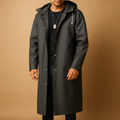 Waterproof long raincoat for men in black with a comfortable fit and full-length design, suitable for walking, camping, and outdoor activities in rainy weather.